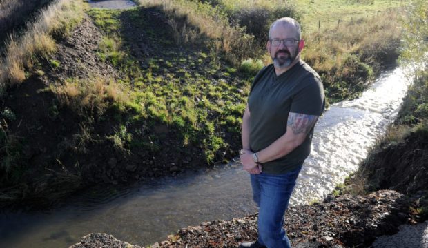 Councillor Mark Findlater beside a bridge near King Edward