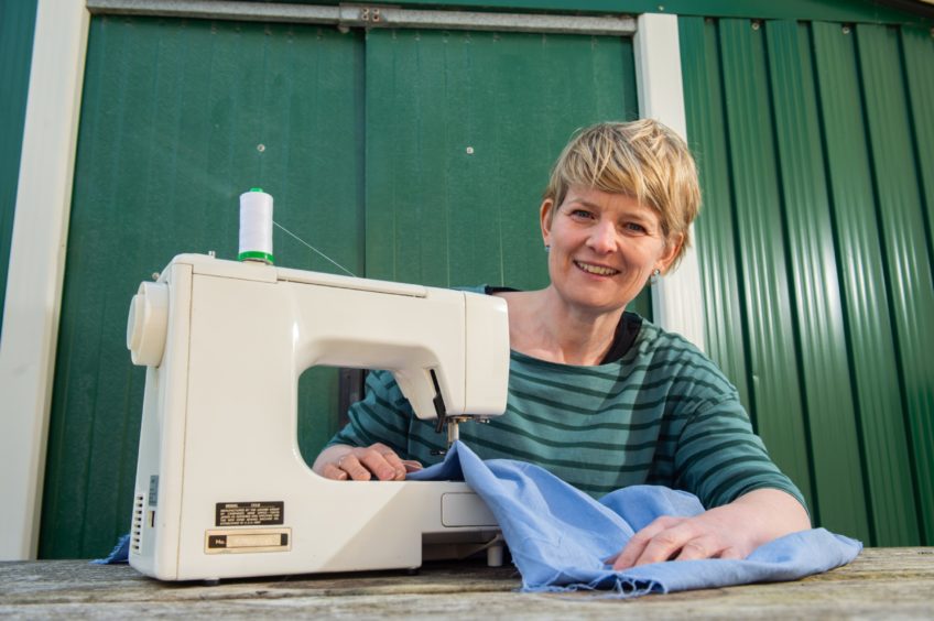 Sylvia Jamieson, volunteer project co-ordinator with Moray Scrubs, turns an old duvet into clothes for medical staff.