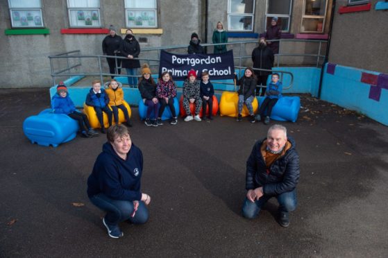 Portgordon Primary head teacher Karen Murray and Kenny Gunn (Chairman of Portgordon Fireworks Group) with the new outdoor seating.