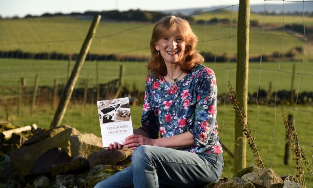 Professor Marjory Harper with her book Testimonies of Transition: Voices from the Scottish Diaspora.