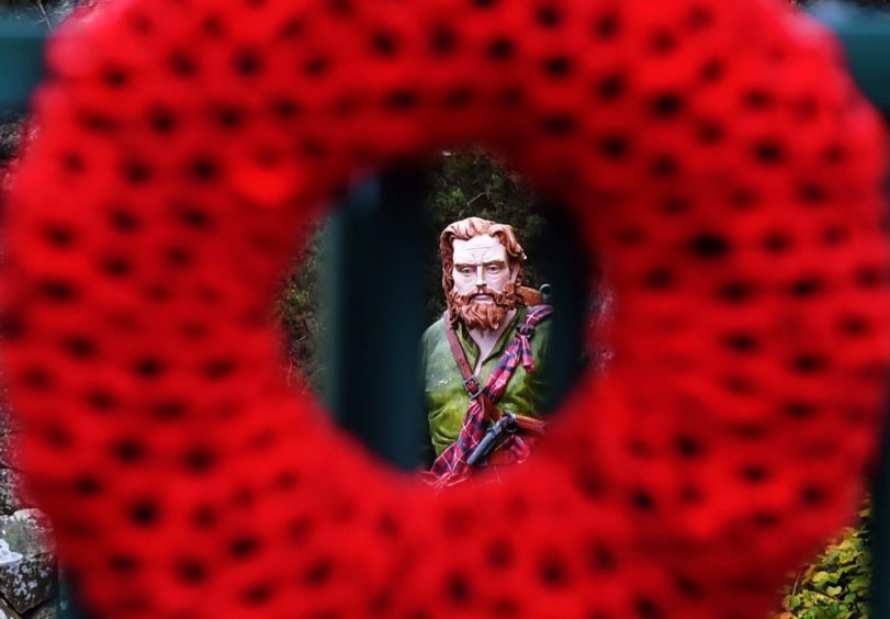 A poppy wreath on the bridge at Peterculter where the Rob Roy statue stands.
