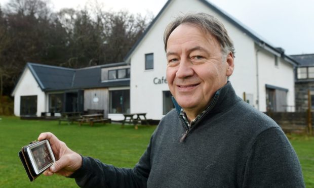 Willie Jack, Chairman of the Assynt Development Trust outside the Mission Hall in Lochinver, Sutherland.