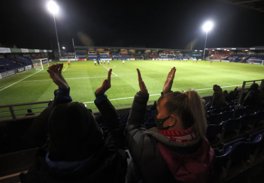 Fans in the stands show their support during the Scottish Premiership match at the Global Energy Stadium, Dingwall.