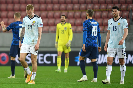Scotland's Oli McBurnie, goalkeeper Craig Gordon and Scott McKenna appear dejected after the final whistle during the UEFA Nations League Group 2, League B match at City Arena, Trnava, Slovakia.