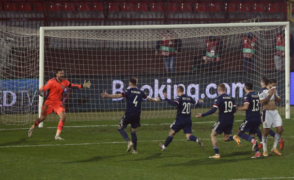 Scotland's David Marshall celebrates saving from Serbia's Aleksandar Mitrovic to win the penalty shootout.