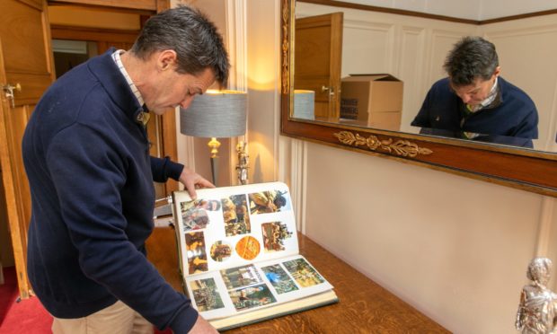 Simon West looks through his career memorabilia.