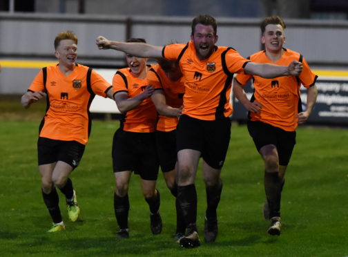 Paul Macleod, centre, celebrates his winning goal for Rothes in the Highland League Cup final.
Pictures by Kenny Elrick