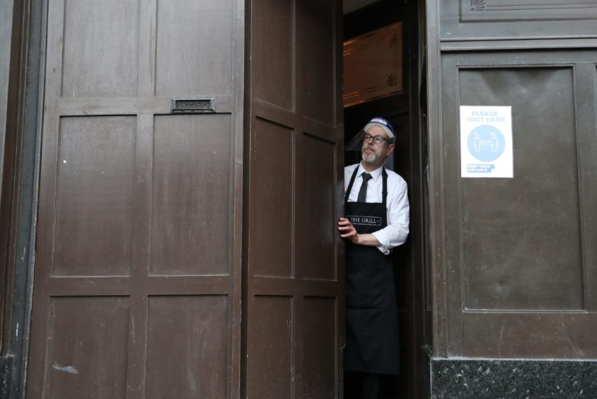 Keith McKenzie closes the door of The Grill in Aberdeen at 5pm, complying with local lockdown measures.