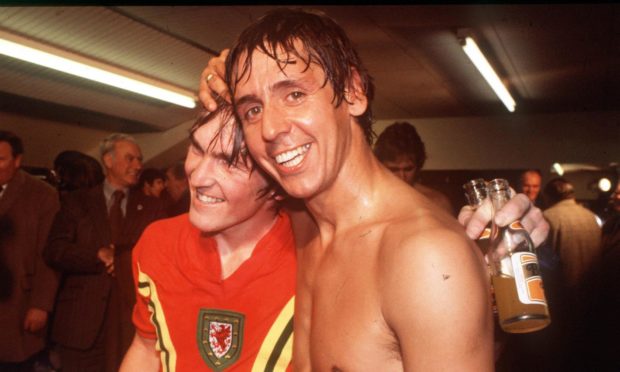 Don Masson and Kenny Dalglish celebrate after victory against Wales in 1977.