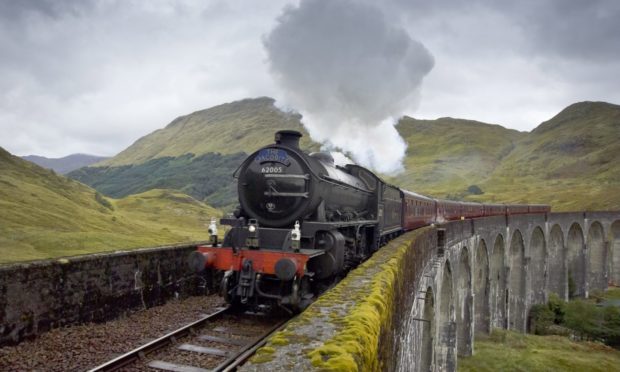 The Jacobite Steam Train crosses the Glenfinnan Viaduct on its way from Fort William to Mallaig.