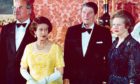 Queen Elizabeth II, West German Chancellor Helmut Kohl, US President Ronald Reagan and Prime Minister Margaret Thatcher at Buckingham Palace, prior to a dinner for summit leaders,1984 Photo by AP/Shutterstock