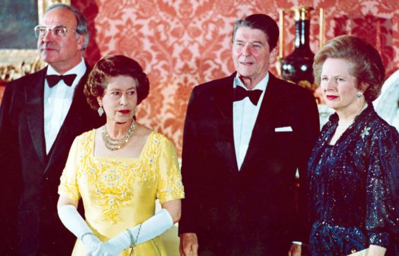 Queen Elizabeth II, West German Chancellor Helmut Kohl, US President Ronald Reagan and Prime Minister Margaret Thatcher at Buckingham Palace, prior to a dinner for summit leaders,1984 Photo by AP/Shutterstock