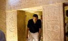 US President Barack Obama ducks his head to get through an entranceway on a tour of the Pyramids and Sphinx in Egypt. On the centre-right of the picture is the hieroglyphic that the President commented on saying it looked like him. Photo by Shutterstock, June 2009