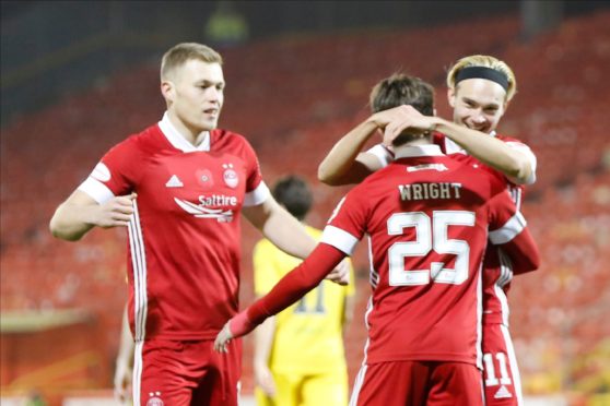 Sam Cosgrove and Ryan Hedges congratulate Scott Wright on his opening goal.