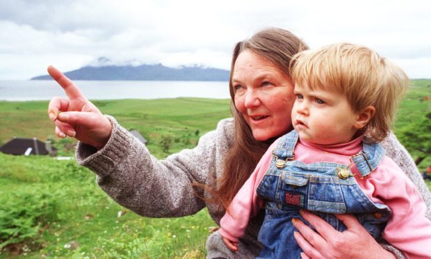 Secretary of the Isle of Eigg Heritage Trust Maggie Fyffe with the island's youngest resident Kirsty Ann Robertson, 15 months