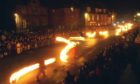 Stonehaven’s Old Town High Street becomes a river of flames during the fireballs ceremony.