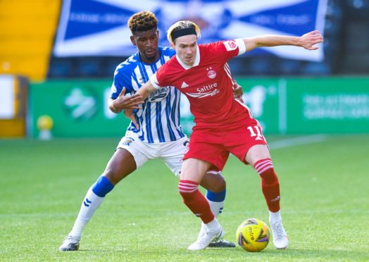 Ryan Hedges holds off Aaron Tshibola.