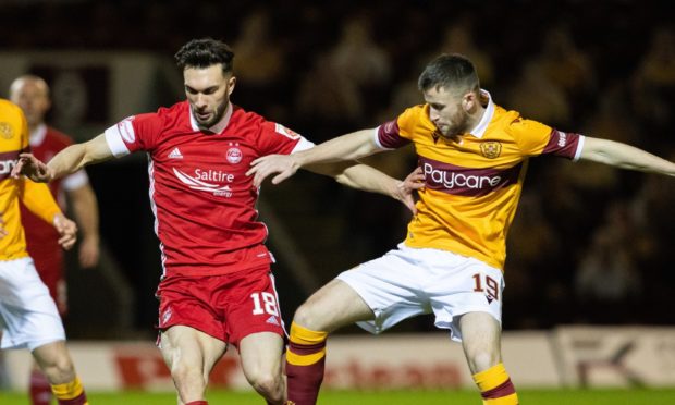 Connor McLennan in action against Motherwell midfielder Liam Polworth.