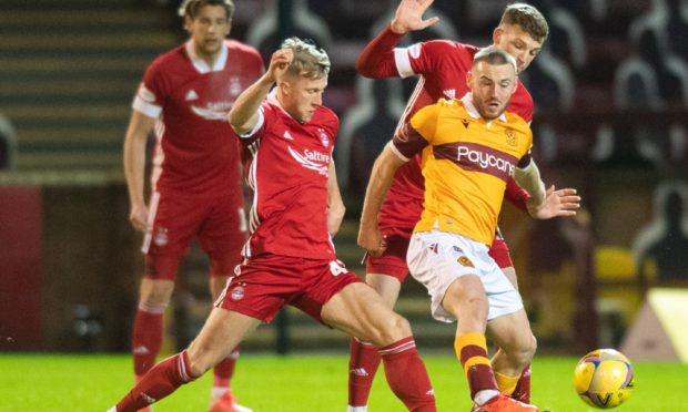 Aberdeen's Ross McCrorie challenges Allan Campbell of Motherwell.