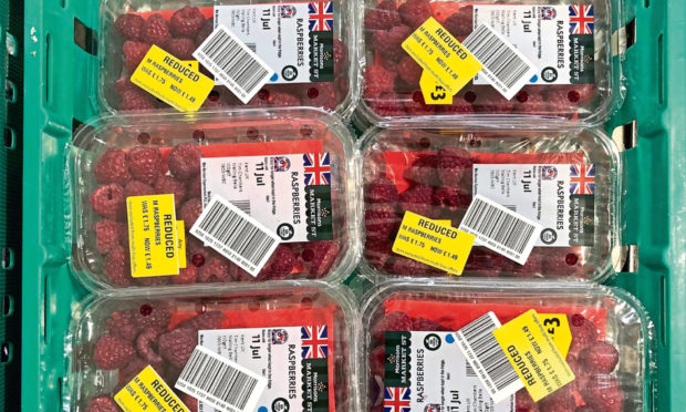 Raspberries reduced in price in a shop to avoid food going to waste.