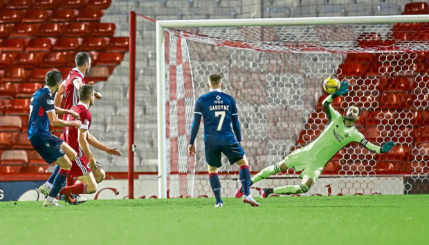 Aberdeen goalkeeper and captain Joe Lewis saves a shot from Ross County's Ross Stewart during Saturday's Premiership meeting.