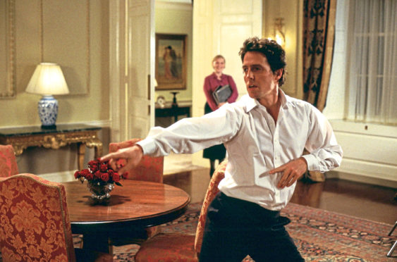 STRUTTING HIS STUFF: Hugh Grant​ dances round Number 10 Downing Street in Love, Actually, a film that is now a Christmas staple.