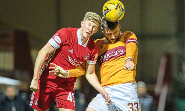 Ross McCrorie, left, challenges for a header for Aberdeen.