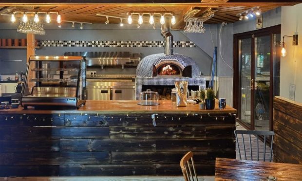 The restaurant's new interior, including pizza oven.