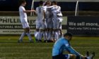 Mitch Megginson celebrating with his Cove teammates after scoring.

Picture by Kenny Elrick
