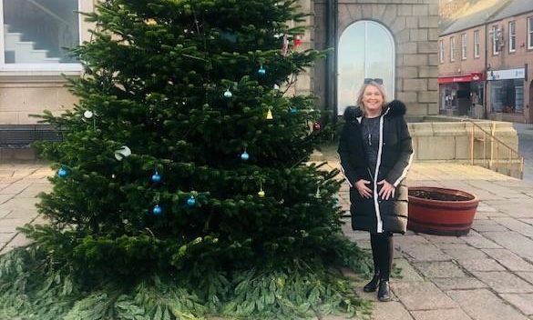 Dianne Beagrie beside the Christmas tree with its new decorations.
