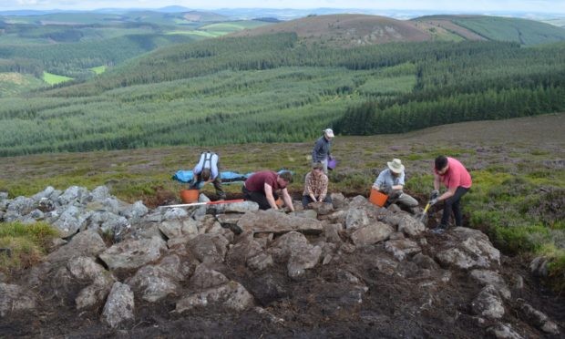 University of Aberdeen of archaeologists at work on Tap O' Noth hill near Rhynie in Aberdeenshire where they have unearthed a "mind-blowing" Pictish site believed to be the largest ever discovered.