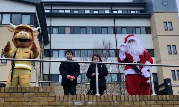 Harry and Ella with Santa and a Firefighter Bull.