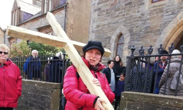 Rev Julia Meason, carrying a cross on the annual Walk of Witness.