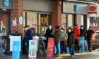 People queueing at the Post Office in Stonehaven, which is incorporated into the Kirkton Road, 
Co-op Petrol Station.