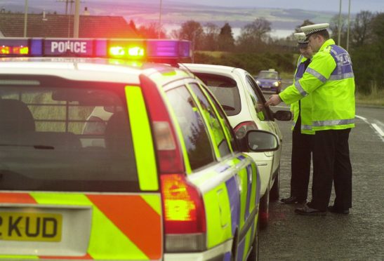 Police officers Brian Logue, left, and Alasdair Goskirk check motorists in an earlier operation in 2020.