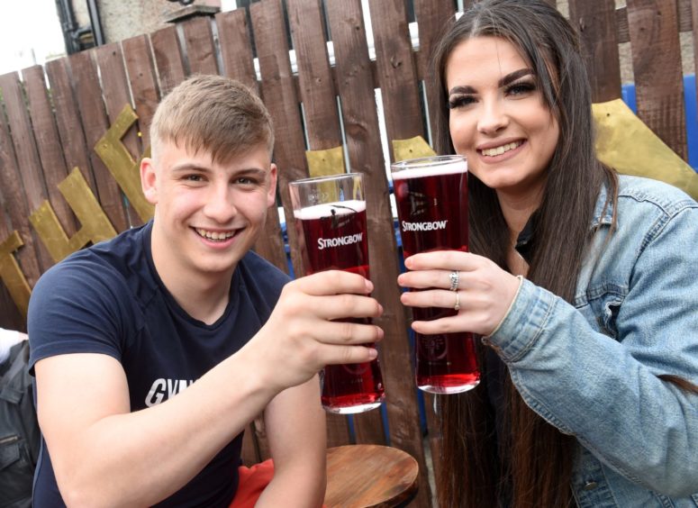 Jordan Morrison and Holly Tomlinson enjoy a drink at The Innes Bar, Inverness, following the reopening of beer gardens.