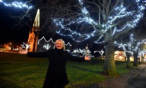 Pictured is Anne Reid, the secretary of Ballater Enhancement Group, in the village square with the Christmas lights.