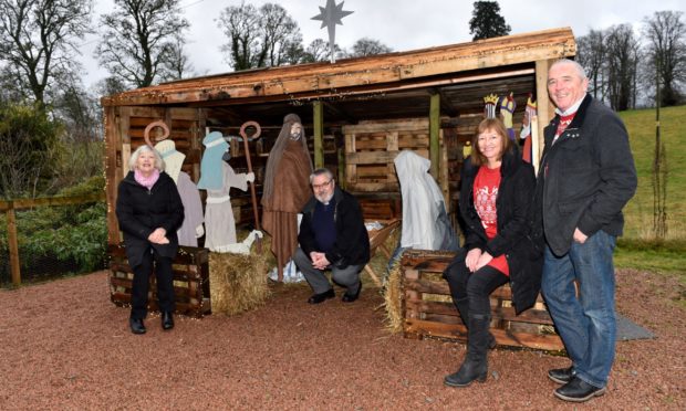 From left: Anne Harrison (session clerk), Euan Glen (Minister) with Lynda and Scott Langlands at their nativity scene barn at Cluny Parish Church, Inverurie.