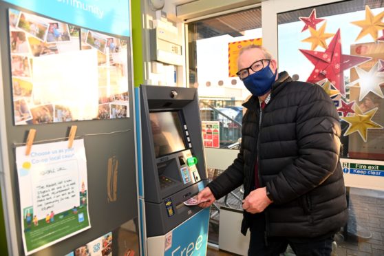 Councillor Ron McKail at the new cash machine at the Coop, Westhill Shopping Centre.