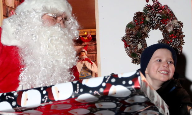 Five-year-old Leo Middleton gets surprised by Santa.
