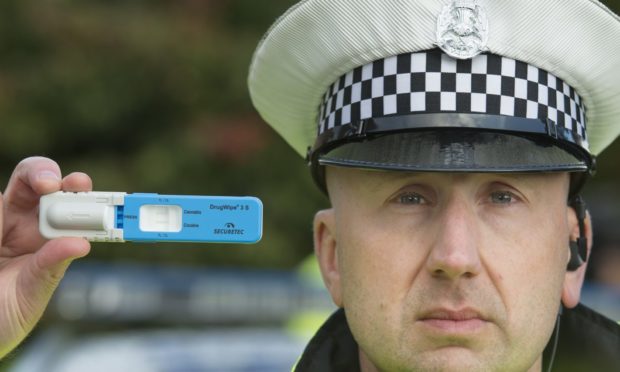 PC Stewart Logan holding one of the Drugswipe testing kits, which can detect 17 different substances. There has been a steep increase in the number of drink and drug drivers in the north-east.