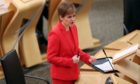 First Minister Nicola Sturgeon giving an update on Covid restrictions in the Scottish Parliament, Edinburgh. PA Photo. Picture date: Tuesday December 22, 2020. See PA story SCOTLAND Coronavirus. Photo credit should read: Russell Cheyne/PA Wire