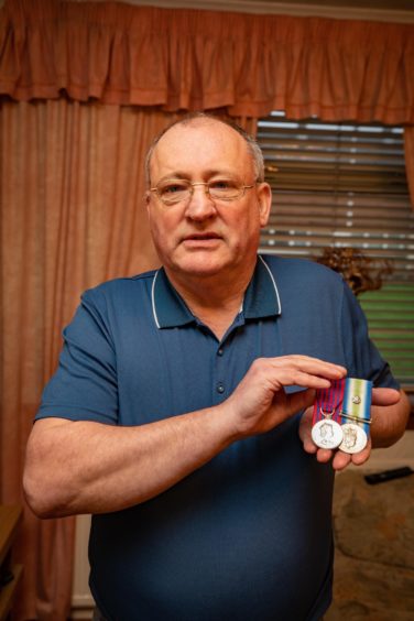 Charles Haffey with the George Medal he was awarded for his part in the Piper Alpha rescue efforts.