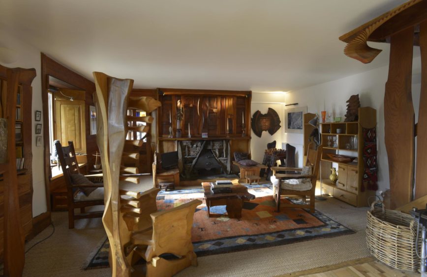 The Tim Stead Trust wishes to purchase the artist's home in the Borders, called The Steading, for the benefit of the nation. The living room, complete with many of Mr Stead's carvings.