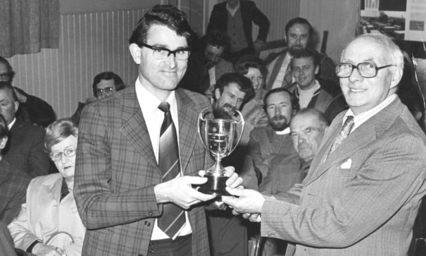 David Dolman is presented a gardening trophy by Gordon District Council chairman James Presley on November 1, 1978.