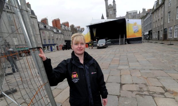 Dawn Schultz, in her time as city promotions manager, sets the stage for the Olympic Torch concert in 2012.