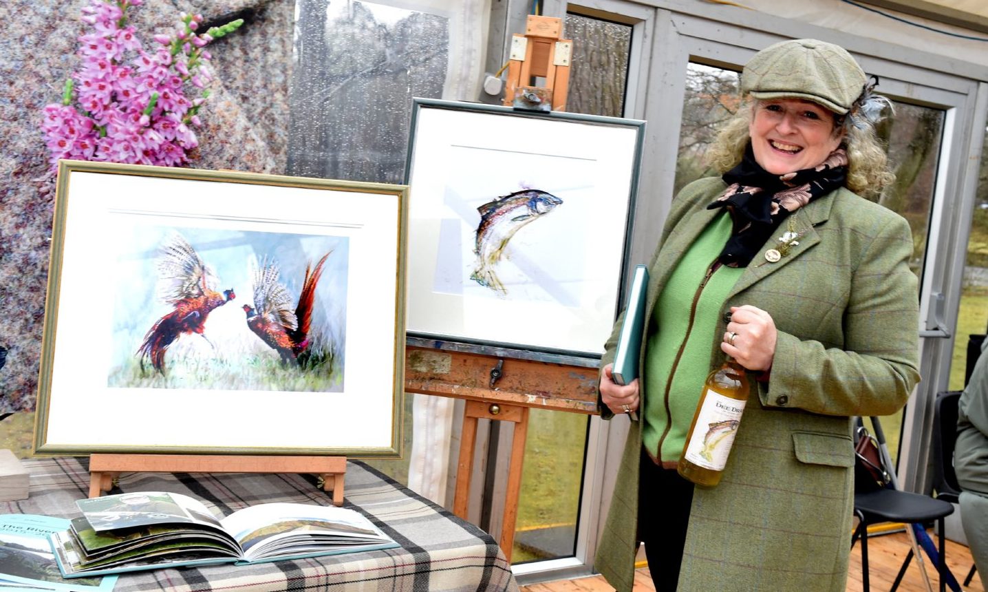 Mel Shand with some of her artworks at the launch of the 2017 River Dee fishing season. Picture by Colin Rennie.
