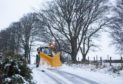 A plough clears snow near Cushnie in Aberdeenshire.