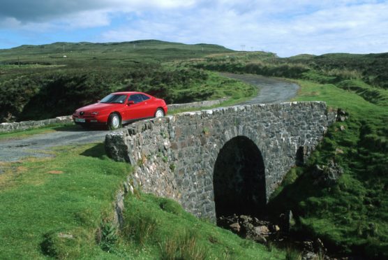 Visitors at the Fairy Bridge on Skye