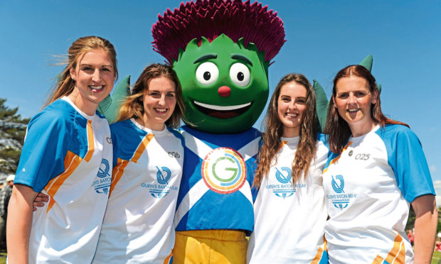 From left, Queen's Baton bearers Sarah Dunnett, Emma Dunnett, Oonagh Dunnett and Sophie Dunnett, all from one family, from Thurso, with Clyde - the official mascot for Glasgow 2014 - in Brora.
